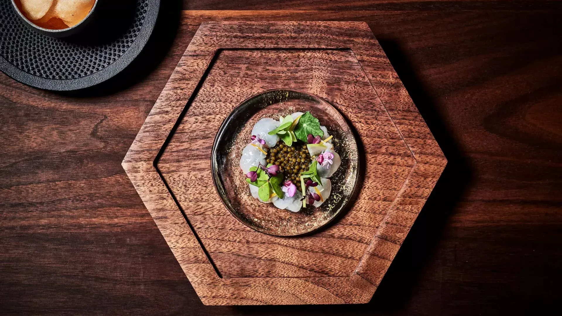 Dish served on hexagonal wooden dish at Aphotic