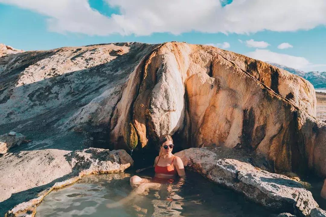A woman relaxes in a natural hot spring beyond San Francisco.